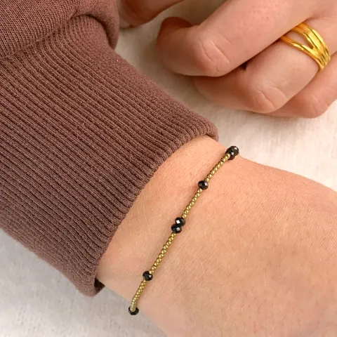 verguld steen armband met hematite en spinel.