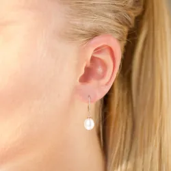 Ovaal 7 - 8 mm aaa-graded zoetwaterparel oorbellen in 14 karaat goud met 