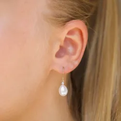 Ovaal 7 - 8 mm aaa-graded zoetwaterparel diamant oorbellen in 14 karaat goud met diamanten 